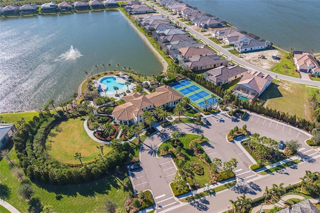 birds eye view of property featuring a water view and a residential view