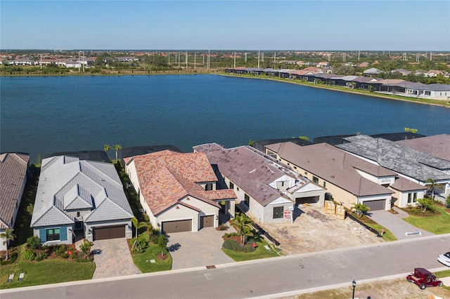 birds eye view of property with a water view and a residential view