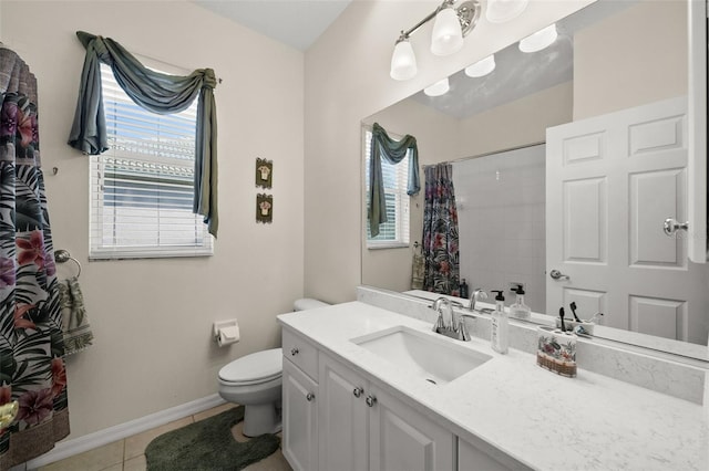 bathroom with curtained shower, toilet, vanity, tile patterned flooring, and baseboards