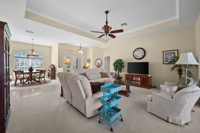 living room featuring light tile patterned floors, visible vents, a raised ceiling, light colored carpet, and french doors