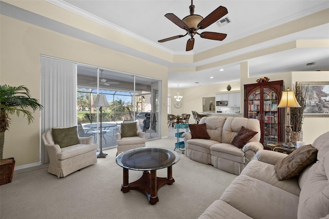 living room featuring visible vents, baseboards, light colored carpet, ceiling fan, and ornamental molding