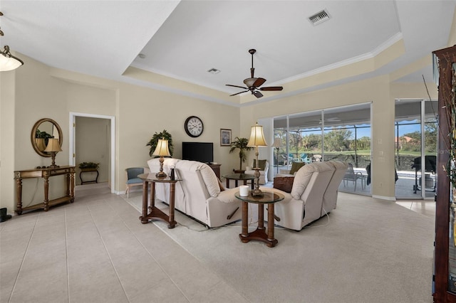 living room featuring light tile patterned floors, a raised ceiling, visible vents, a sunroom, and ceiling fan