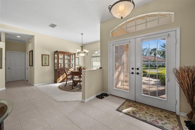 foyer featuring french doors, visible vents, baseboards, and light tile patterned floors