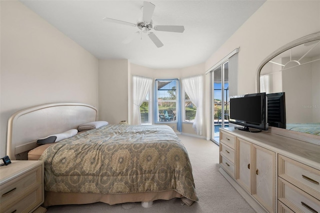 bedroom with access to exterior, ceiling fan, baseboards, and light colored carpet