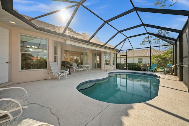 outdoor pool featuring a lanai and a patio area