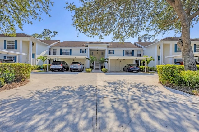 multi unit property featuring a residential view and concrete driveway