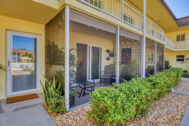 doorway to property featuring stucco siding