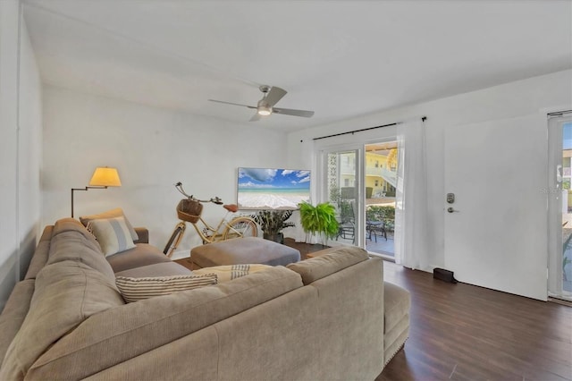 living area featuring ceiling fan and dark wood finished floors