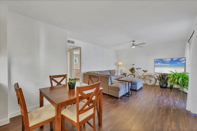 dining space featuring visible vents, wood finished floors, a ceiling fan, and baseboards