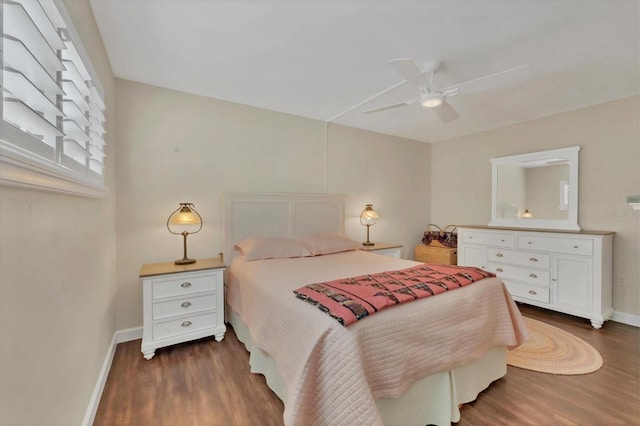 bedroom with a ceiling fan, dark wood-style flooring, and baseboards