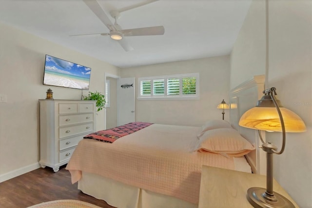 bedroom with baseboards, dark wood finished floors, and a ceiling fan