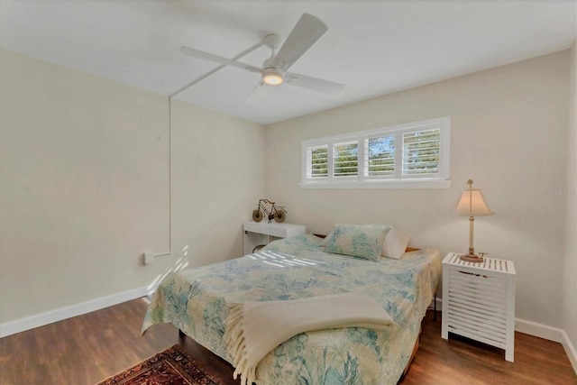 bedroom with a ceiling fan, baseboards, and wood finished floors