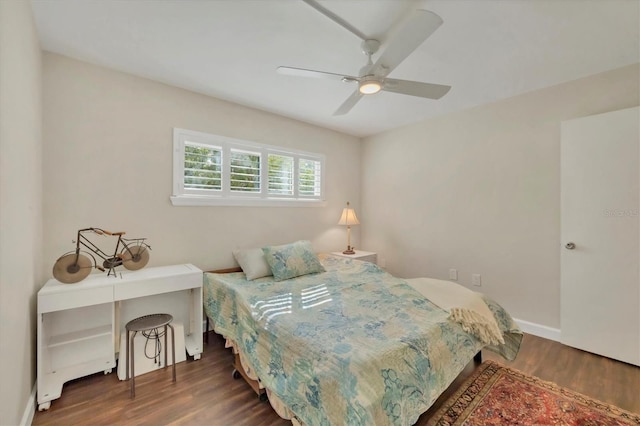 bedroom with ceiling fan, baseboards, and wood finished floors