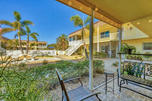 balcony featuring stairway and a patio