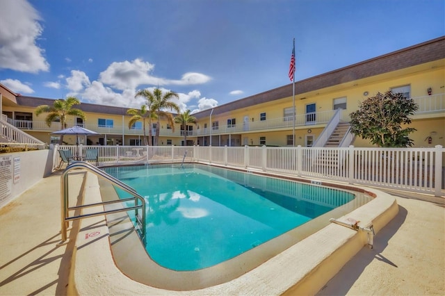 community pool featuring fence