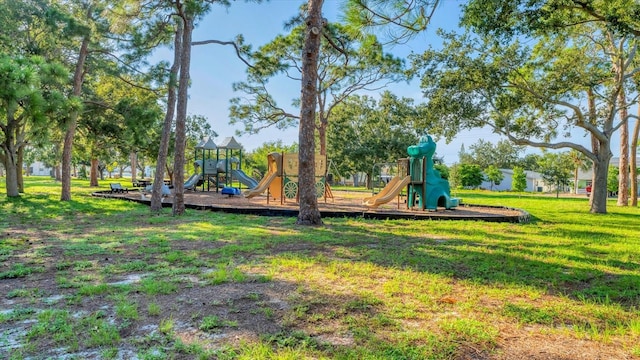 community jungle gym featuring a lawn