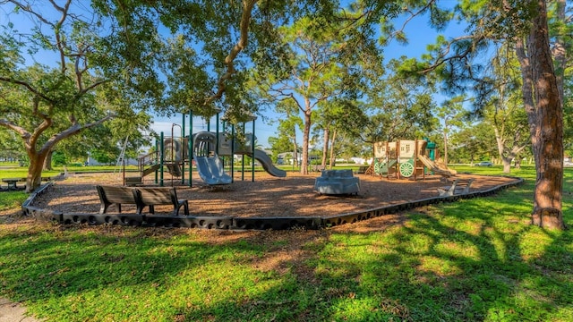 community jungle gym featuring a lawn