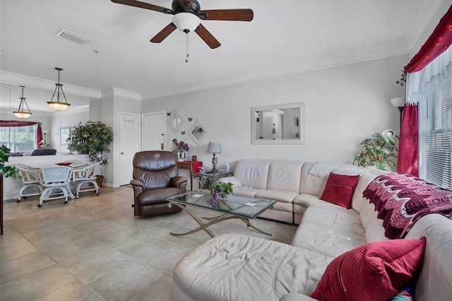 living area with ceiling fan, visible vents, and crown molding