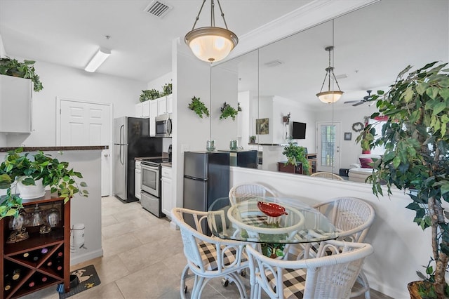 dining area with visible vents and light tile patterned floors