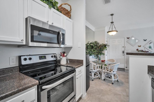 kitchen with dark countertops, visible vents, appliances with stainless steel finishes, ornamental molding, and white cabinetry