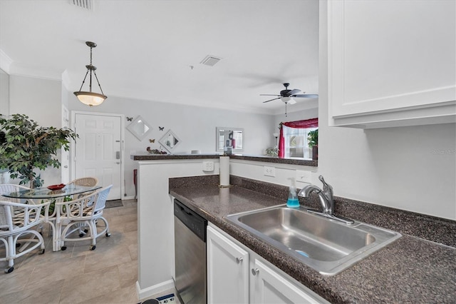 kitchen featuring visible vents, ornamental molding, stainless steel dishwasher, white cabinetry, and a sink