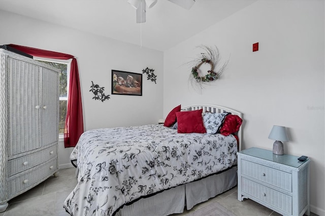 bedroom featuring baseboards, a ceiling fan, and tile patterned floors