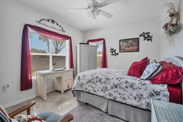 bedroom featuring light tile patterned floors, a ceiling fan, and baseboards