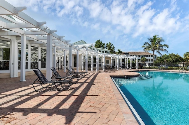 community pool with a patio and a pergola