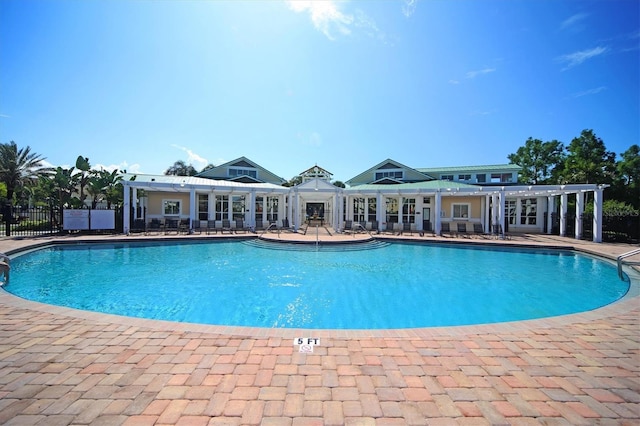 pool featuring a patio area, fence, and a pergola