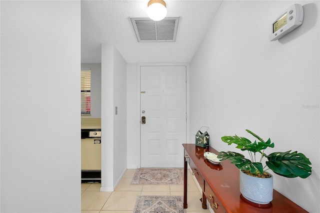 interior space with light tile patterned floors, baseboards, and visible vents