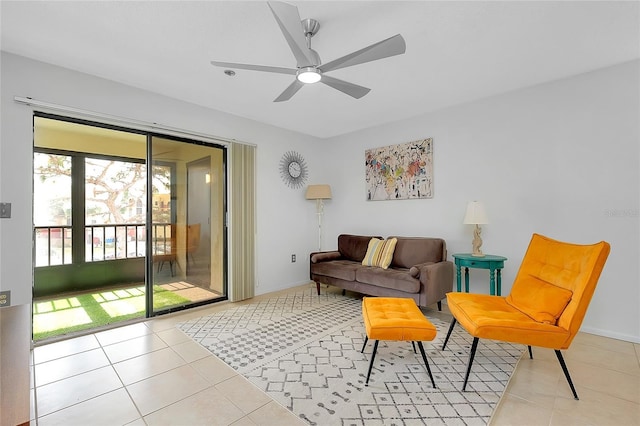 living area with ceiling fan, tile patterned flooring, and baseboards