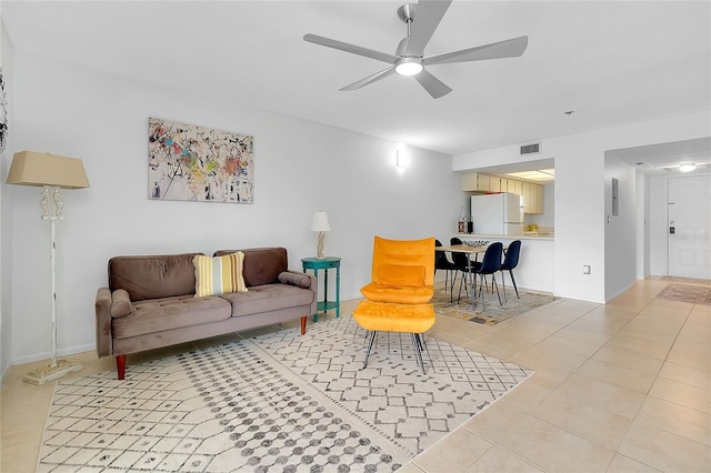 living room with visible vents, ceiling fan, baseboards, and light tile patterned flooring