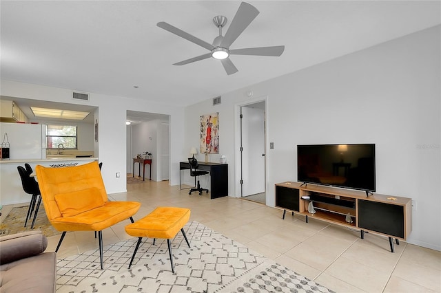 living room with light tile patterned floors, ceiling fan, and visible vents