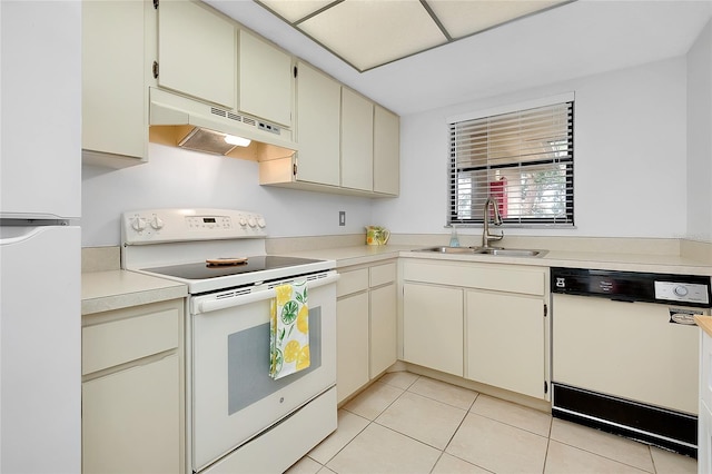 kitchen featuring light tile patterned floors, cream cabinets, under cabinet range hood, white appliances, and a sink