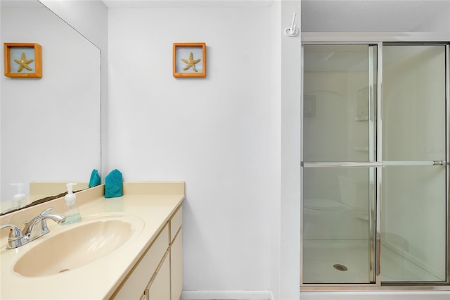 full bath with a shower stall and vanity