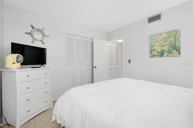 bedroom featuring light colored carpet, a closet, and visible vents