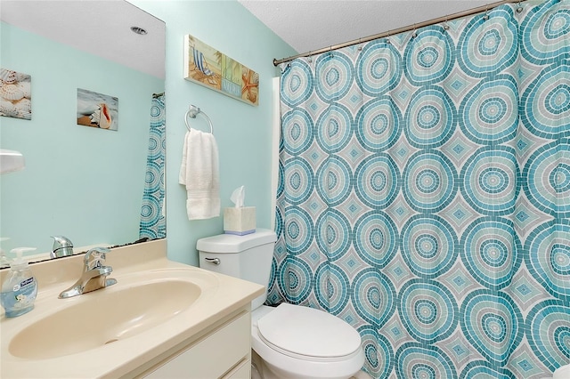 bathroom featuring toilet, a shower with curtain, a textured ceiling, and vanity