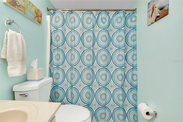 full bath with toilet, curtained shower, a textured ceiling, and vanity