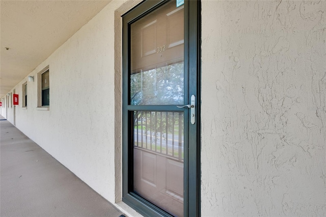 view of exterior entry with stucco siding