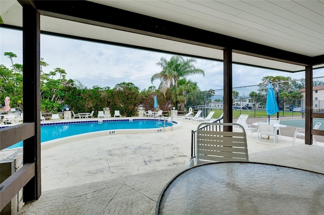 pool featuring a patio area and fence