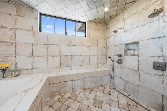 bathroom featuring a garden tub and a tile shower