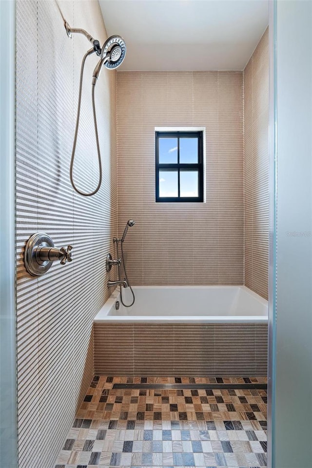 bathroom with a tile shower and a bath