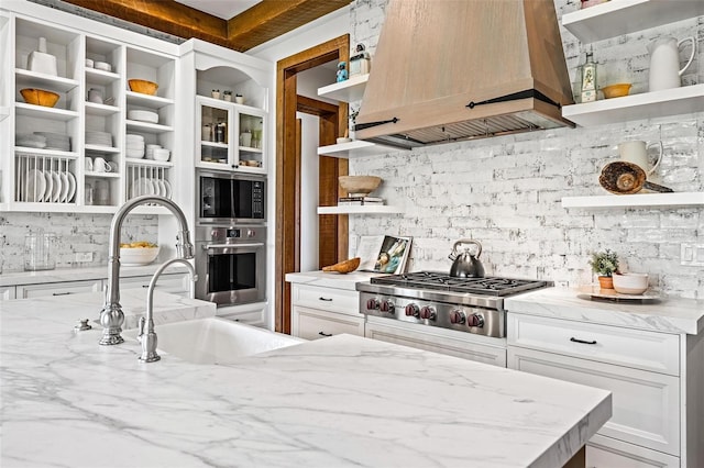 kitchen with open shelves, appliances with stainless steel finishes, custom exhaust hood, and tasteful backsplash