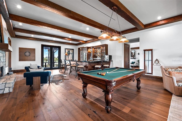 playroom with baseboards, a fireplace, a bar, and hardwood / wood-style flooring