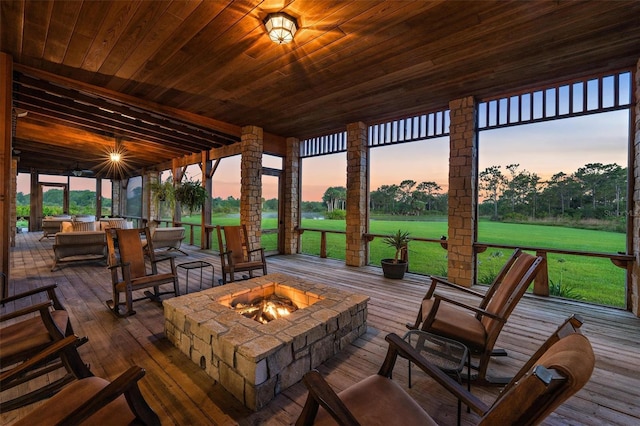 deck at dusk with a fire pit