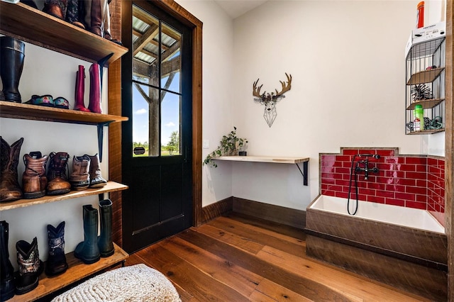 entrance foyer featuring baseboards and dark wood finished floors