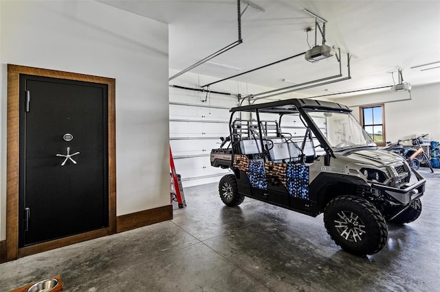 garage with a garage door opener and baseboards