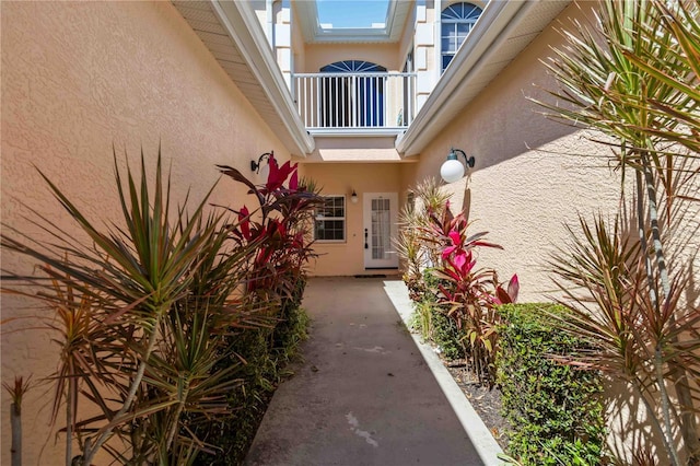 entrance to property featuring stucco siding