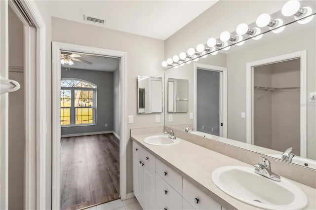 full bathroom featuring double vanity, visible vents, and a sink