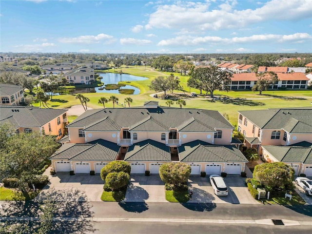 drone / aerial view featuring a residential view and a water view